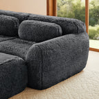 Armrest and cushion detail of the 149'' modular plush sofa in dark grey, showing its soft curves and fluffy texture.