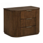 Modern brown solid wood nightstand with a fluted texture, curved sides, and three drawers featuring slim gold handles.