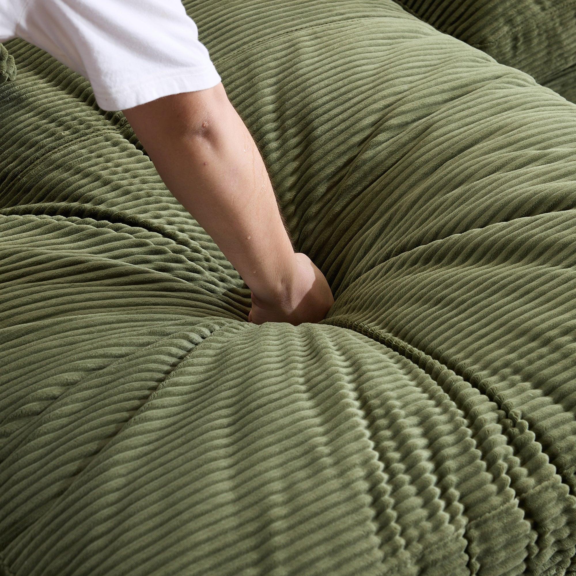 Green Corduroy Sofa with Cushions and Pillows.