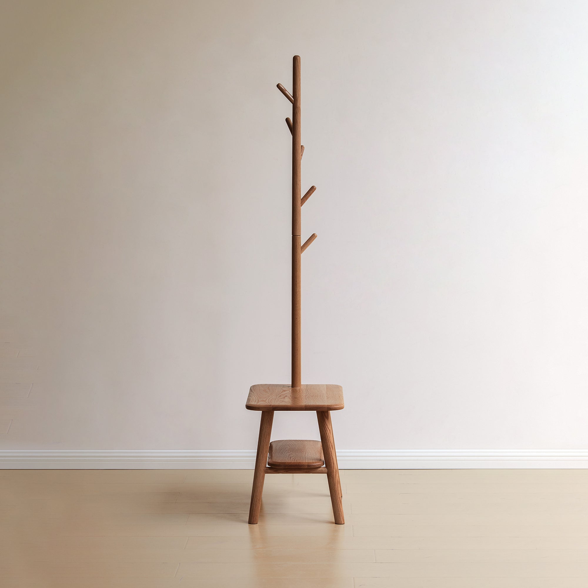 Front view of Solid Wood Shoe Stool with Coat Hanger, showcasing minimalist oak design with integrated bench and vertical hanging pegs.