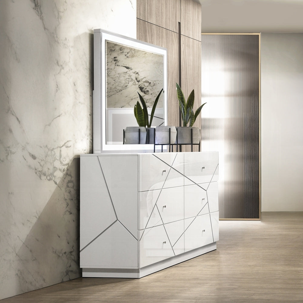 Modern white dresser with 6 drawers in a stylish room setup, paired with a mirror and plants. Embossed lines add a sleek, contemporary touch.