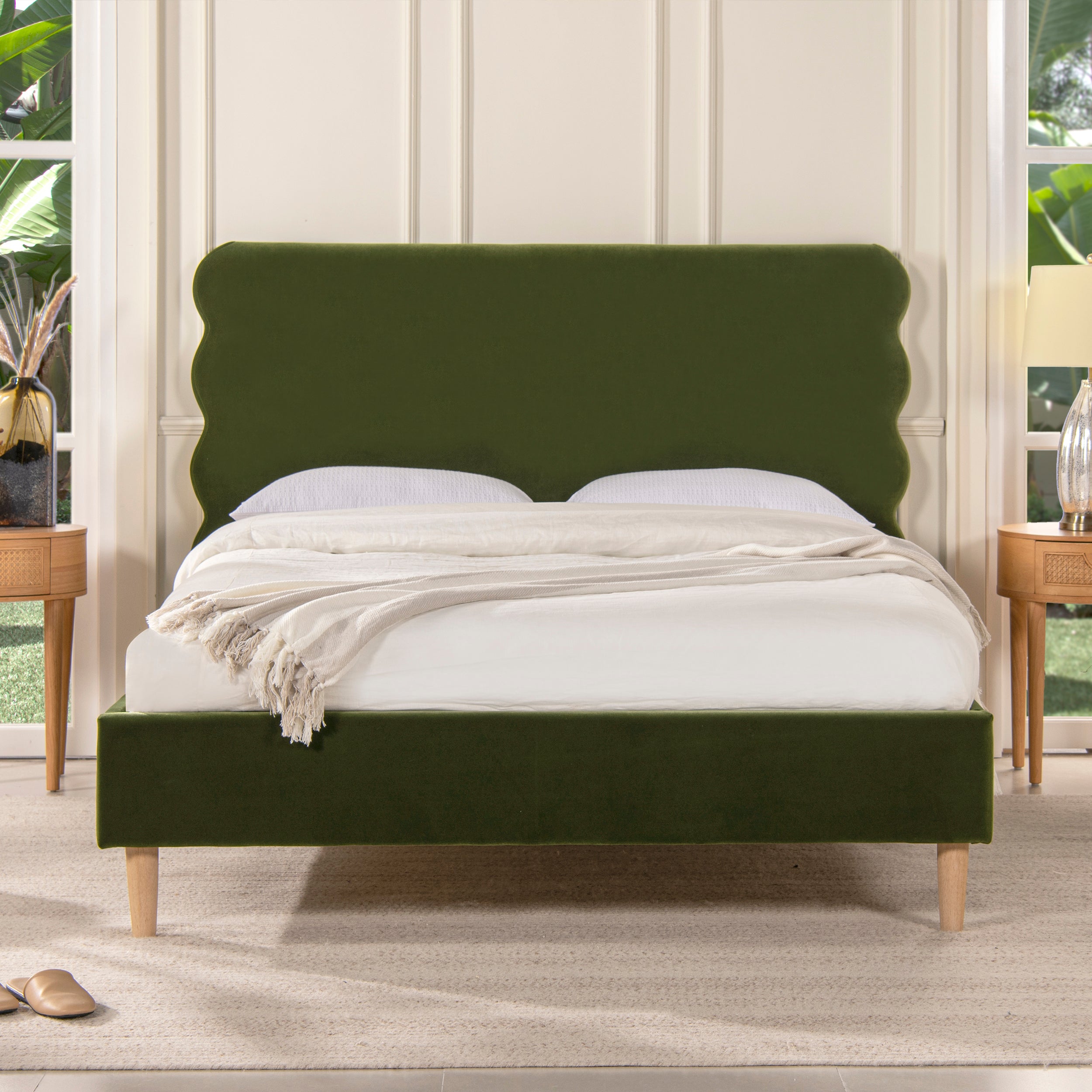 Stockholm Modern Wavy Headboard Platform Bed in queen size with olive green velvet upholstery and wooden legs, styled in a modern bedroom.