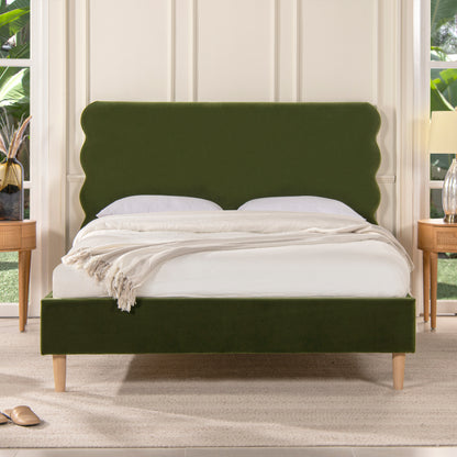 Stockholm Modern Wavy Headboard Platform Bed in queen size with olive green velvet upholstery and wooden legs, styled in a modern bedroom.
