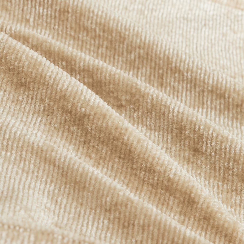 Close-up of soft velvet fabric texture in light camel color. Featured on the Modular Velvet Sectional Sofa for a luxurious feel.