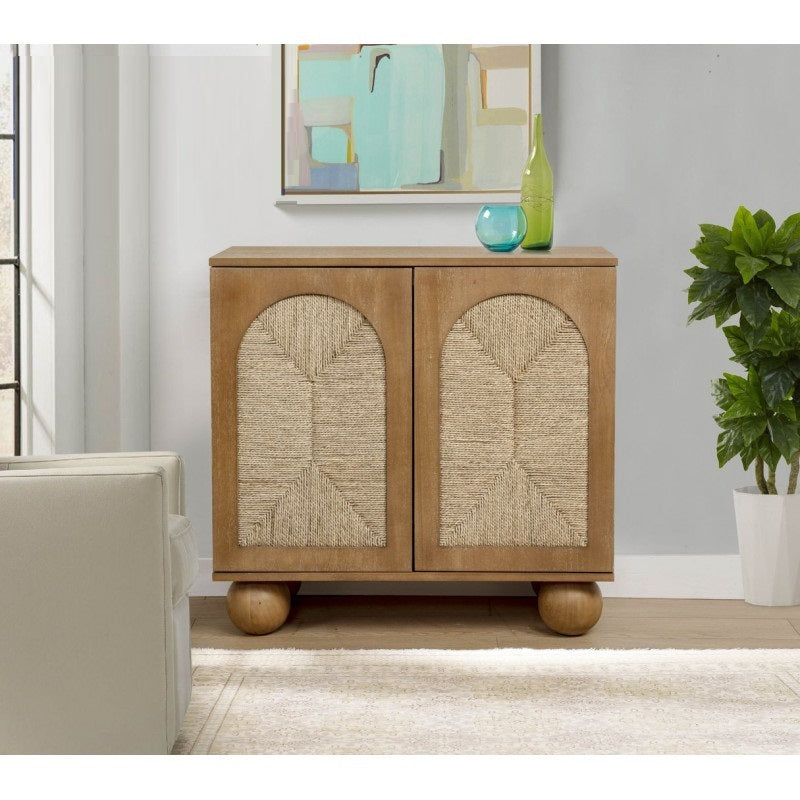 Boho light brown storage cabinet with arched, woven-rope front panels and unique wooden ball-style feet.