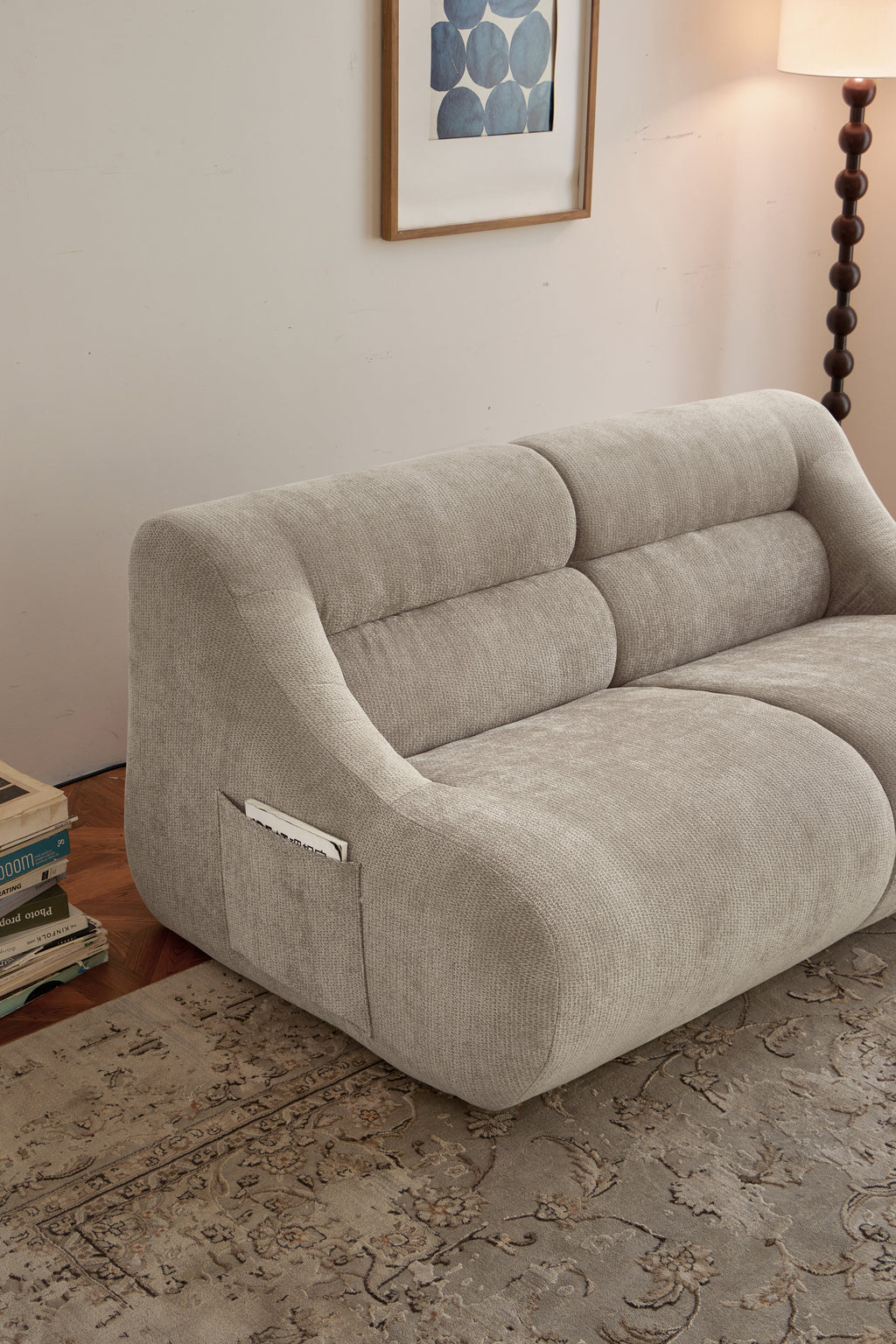 Close-up side view of beige memory foam 2-seater sofa with curved design and storage pocket, ideal for easy setup in small spaces.