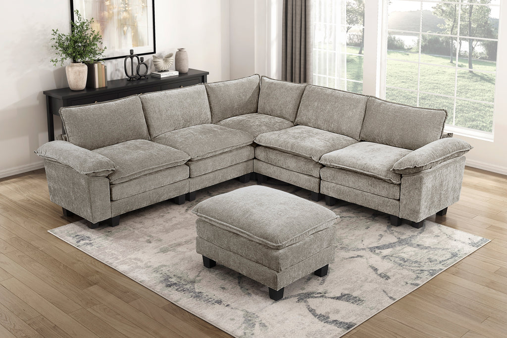 Modern gray modular sectional sofa in plush chenille fabric with a matching ottoman on a patterned area rug.