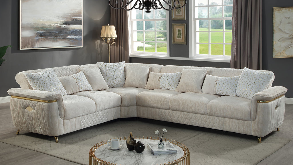 Contemporary beige reversible sectional sofa with a wooden frame, quilted accents, and elegant gold-tone metal base.