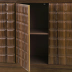 Close-up of open geometric doors on 4-door storage cabinet, highlighting textured wood pattern and metal trim accents.