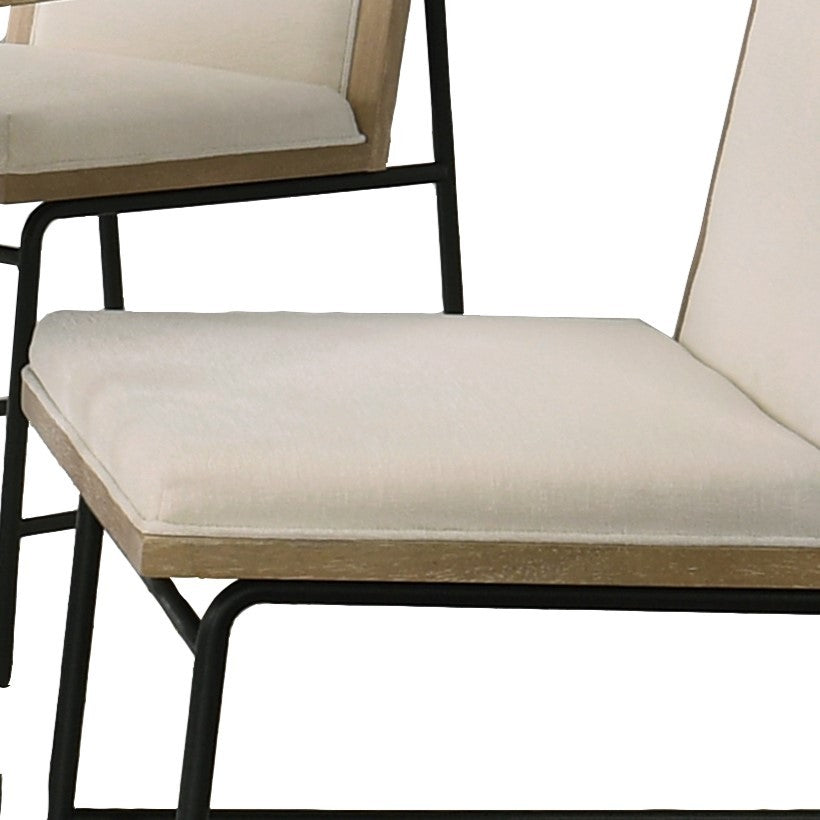 Close-up of the cream upholstered seat cushions on the dining chairs, offering comfort and modern style.