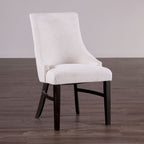 Transitional arm chair with padded wingback in beige fabric and black wood legs, ideal for modern dining room settings.