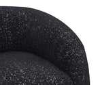 Detail view of curved backrest and boucle fabric on black swivel chair. High-density foam ensures plush seating comfort.