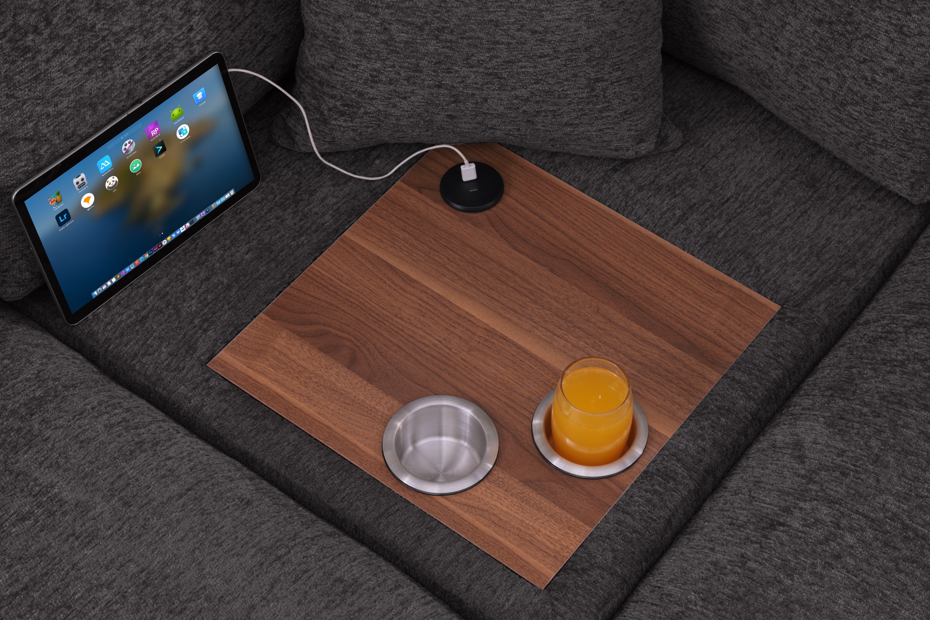 Close-up of built-in wood tray with USB charging port and dual cupholders on gray chenille sectional sofa, showcasing tech convenience.