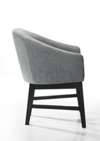 Side profile of Haven 7Pc Dining Set - Round Ebony gray barrel chair highlighting its ergonomic curve and modern black wood legs.