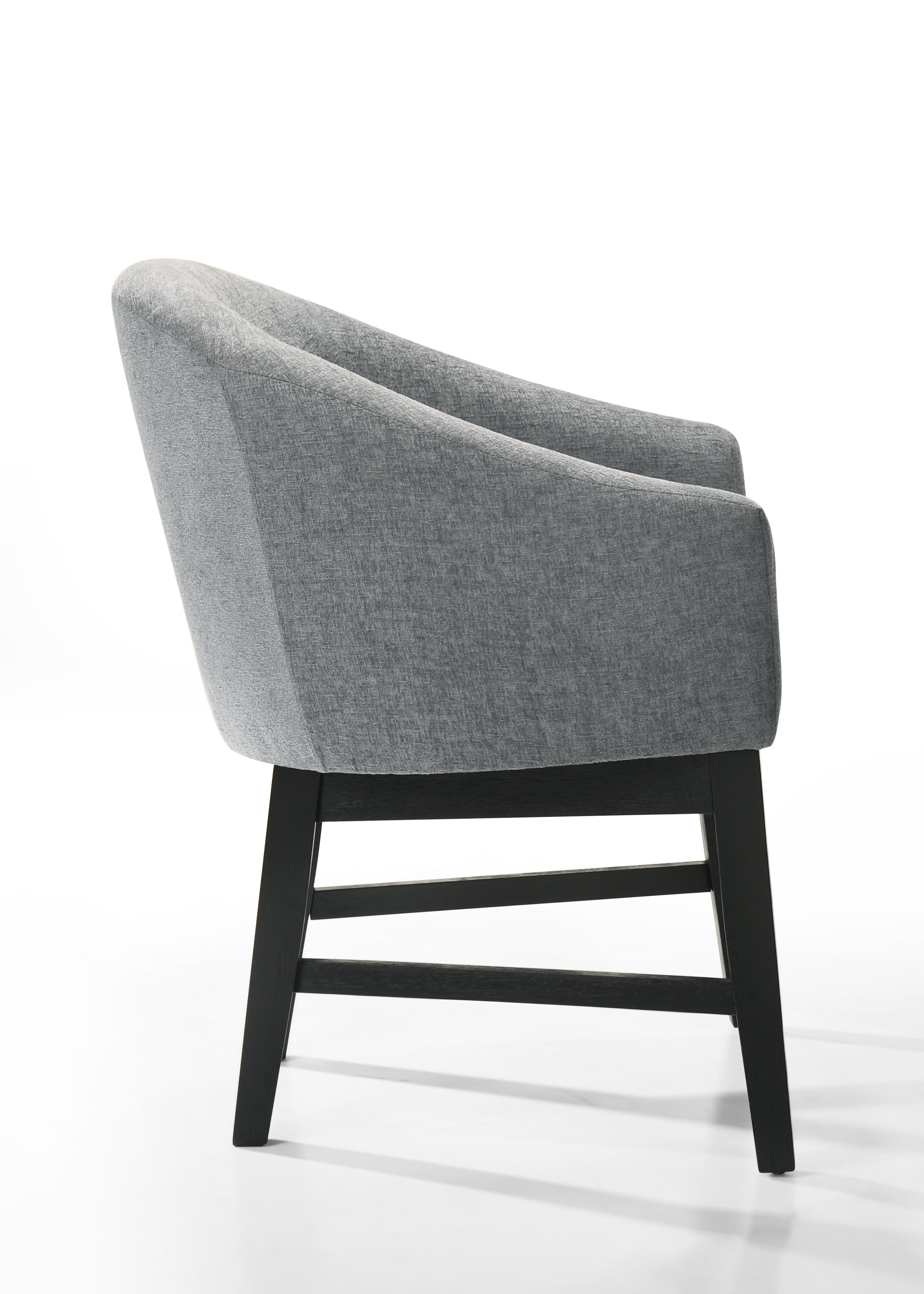 Side profile of Haven 7Pc Dining Set - Round Ebony gray barrel chair highlighting its ergonomic curve and modern black wood legs.