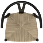 Top-down view of matte black beech wood dining chair highlighting the detailed handwoven seat pattern and curved backrest.