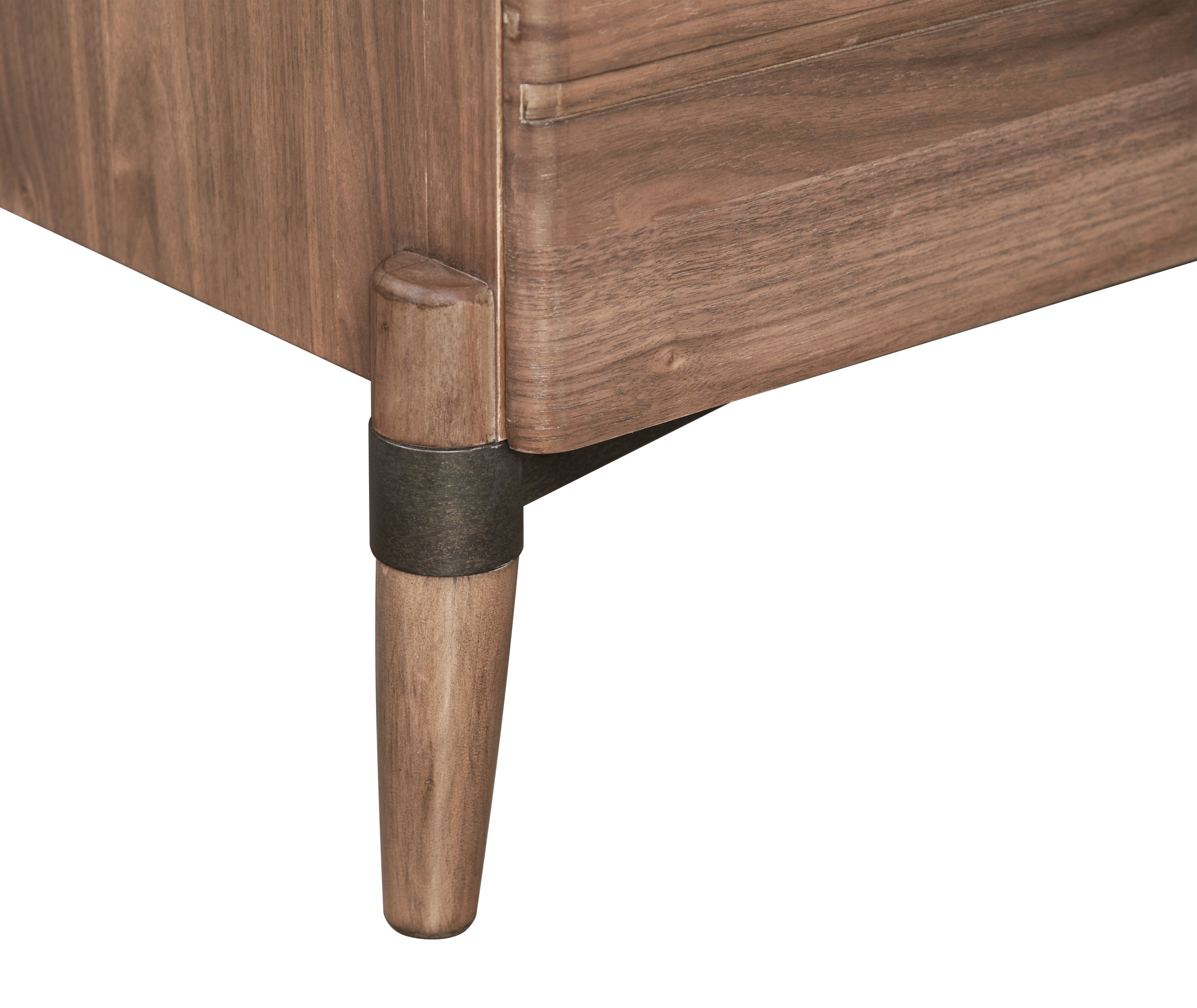 Detail of walnut dresser leg with bronze accent. Sturdy tapered legs support the dresser’s modern aesthetic.