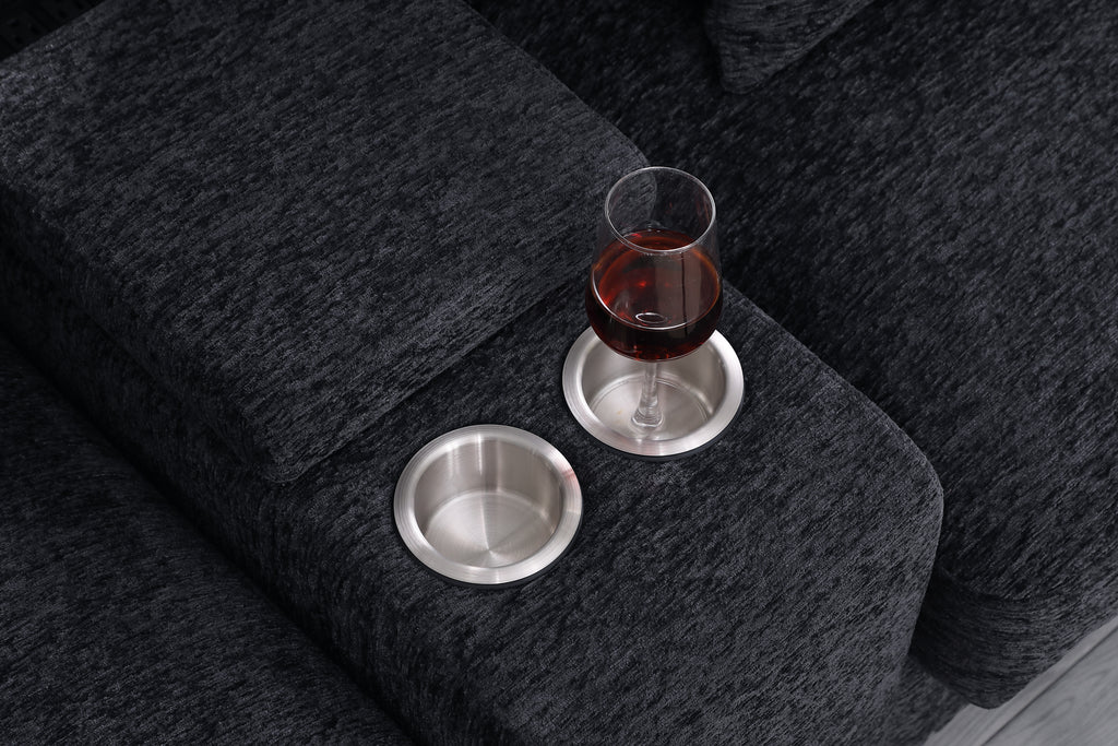 Close-up of stainless steel cupholders on Celine sectional sofa armrest. Dark gray fabric with modern living room features.