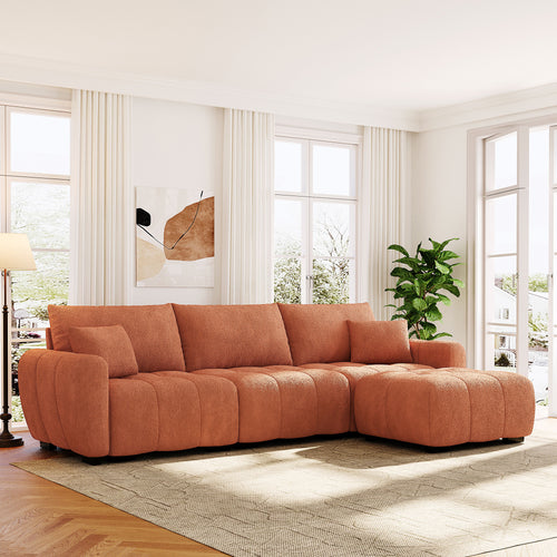 Modular sectional sofa with ottoman in boucle fabric shown in a bright living room, offering a cozy and modern seating solution.