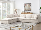 Modular sectional sofa with ottoman in a bright living room, styled with modern decor and natural light for a welcoming atmosphere.