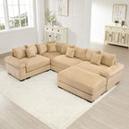 Oversized camel corduroy modular sectional sofa with extra-thick armrests and a matching ottoman in a bright living room.