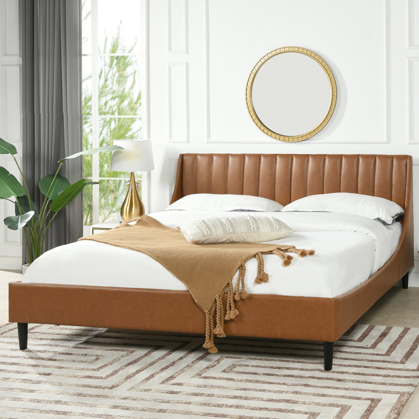 Aspen king faux leather platform bed in caramel tan brown, styled in a bright bedroom with modern decor and neutral tones.