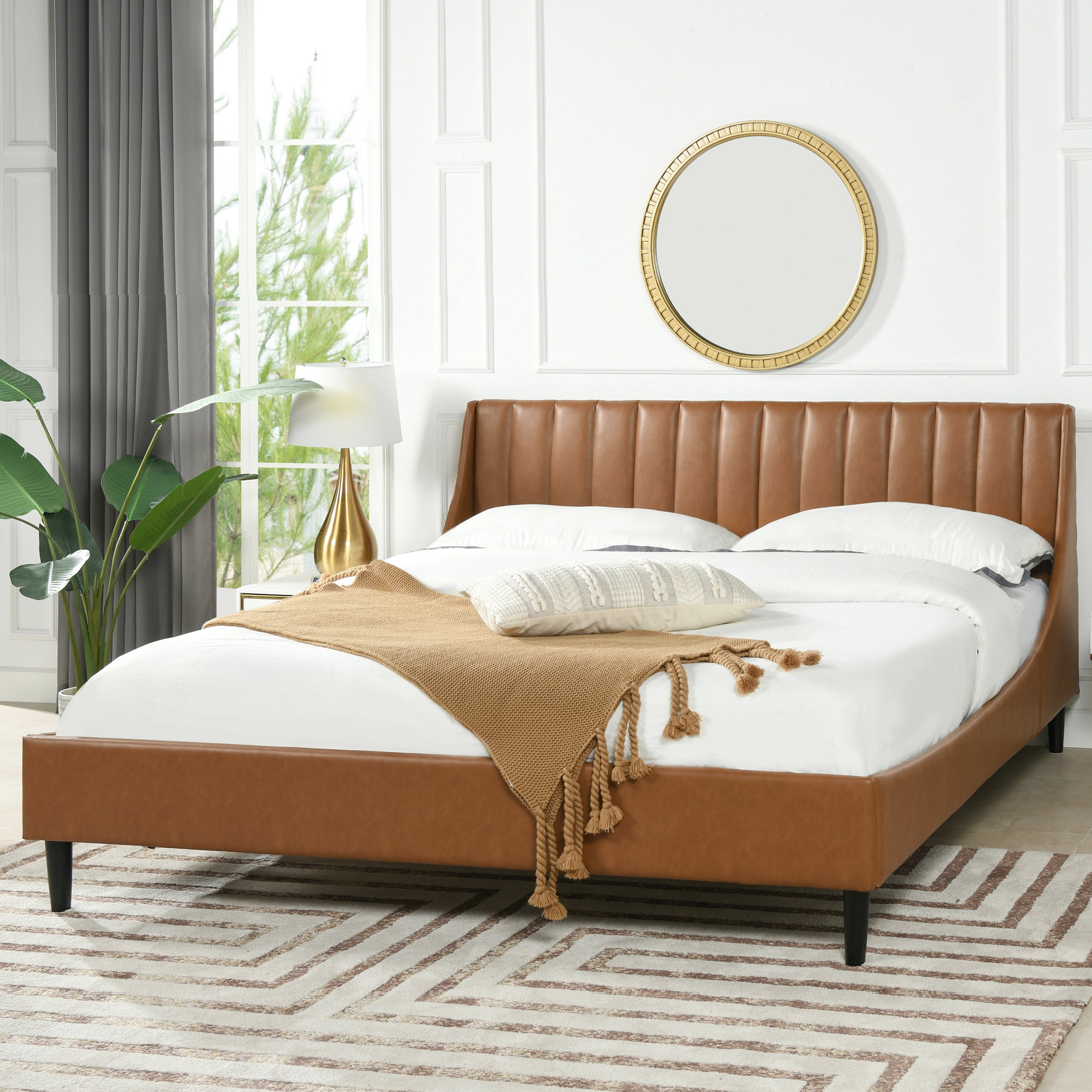 Aspen king faux leather platform bed in caramel tan brown, styled in a bright bedroom with modern decor and neutral tones.