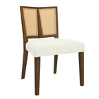 Angled front view of a mid-century dining chair featuring a cushioned seat and rattan backrest with a dark wood frame.