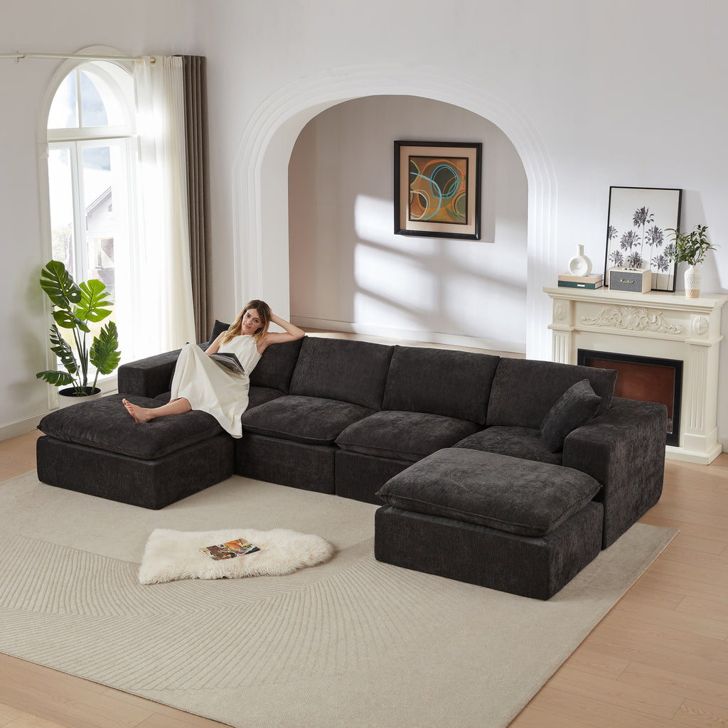 Chenille Cloud Sofa - Modern Comfort sectional in dark gray with a woman lounging, ideal for stylish living rooms or apartments.