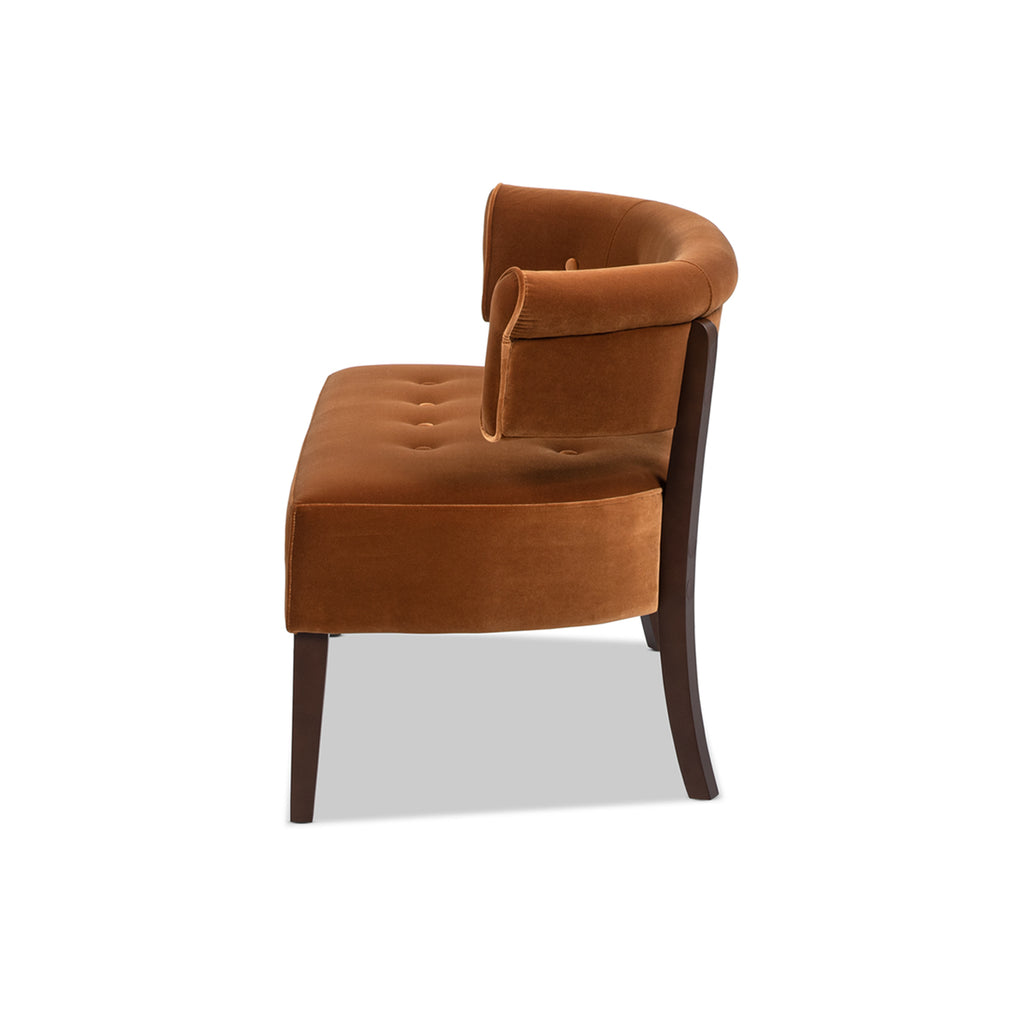 Side profile of Burnt Orange Velvet Bench showing curved backrest and tapered wood legs in a mid-century modern frame.