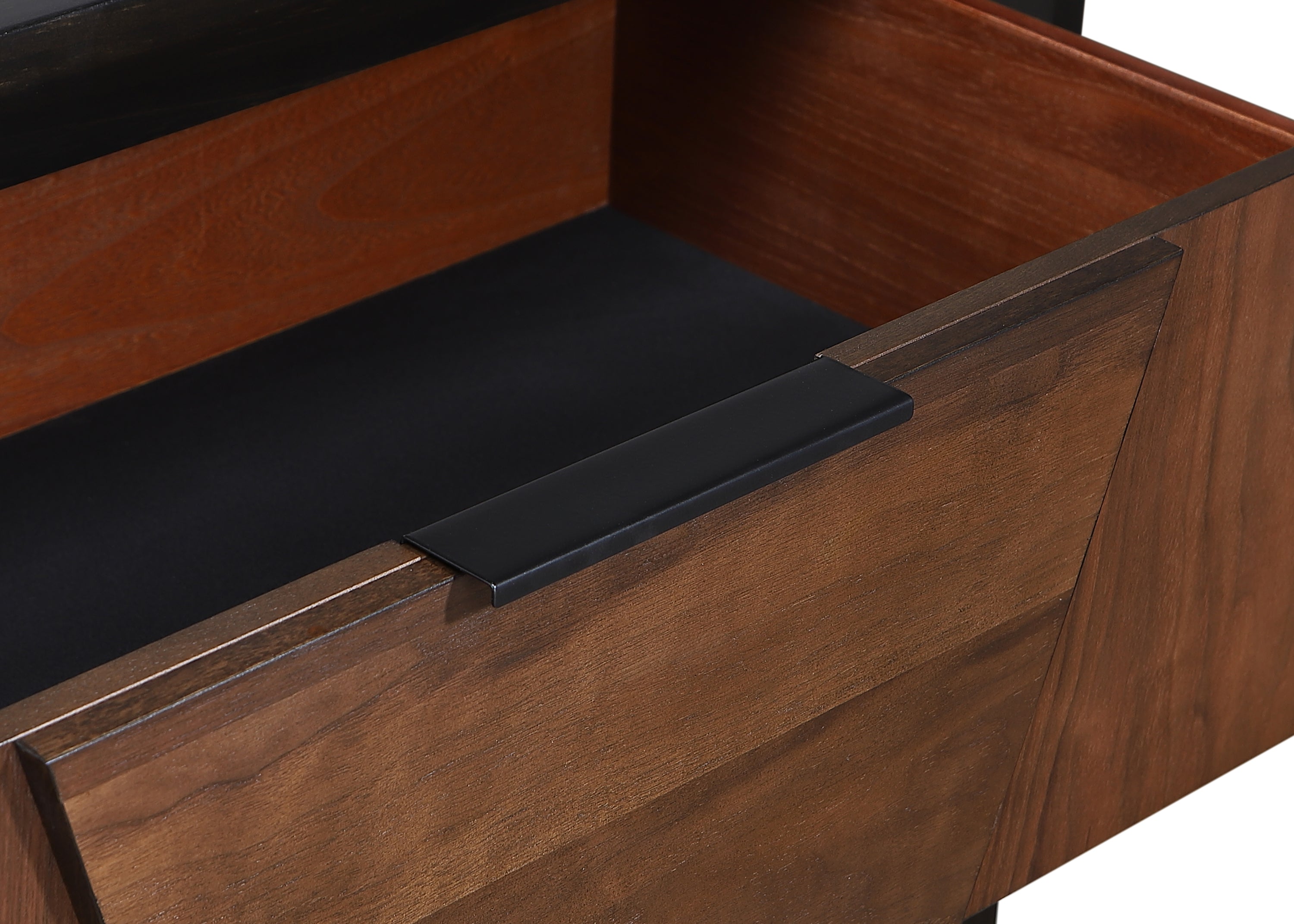 Close-up of Houston 5-Drawer Chest - Walnut showing solid wood drawer with black metal handle and smooth interior lining.