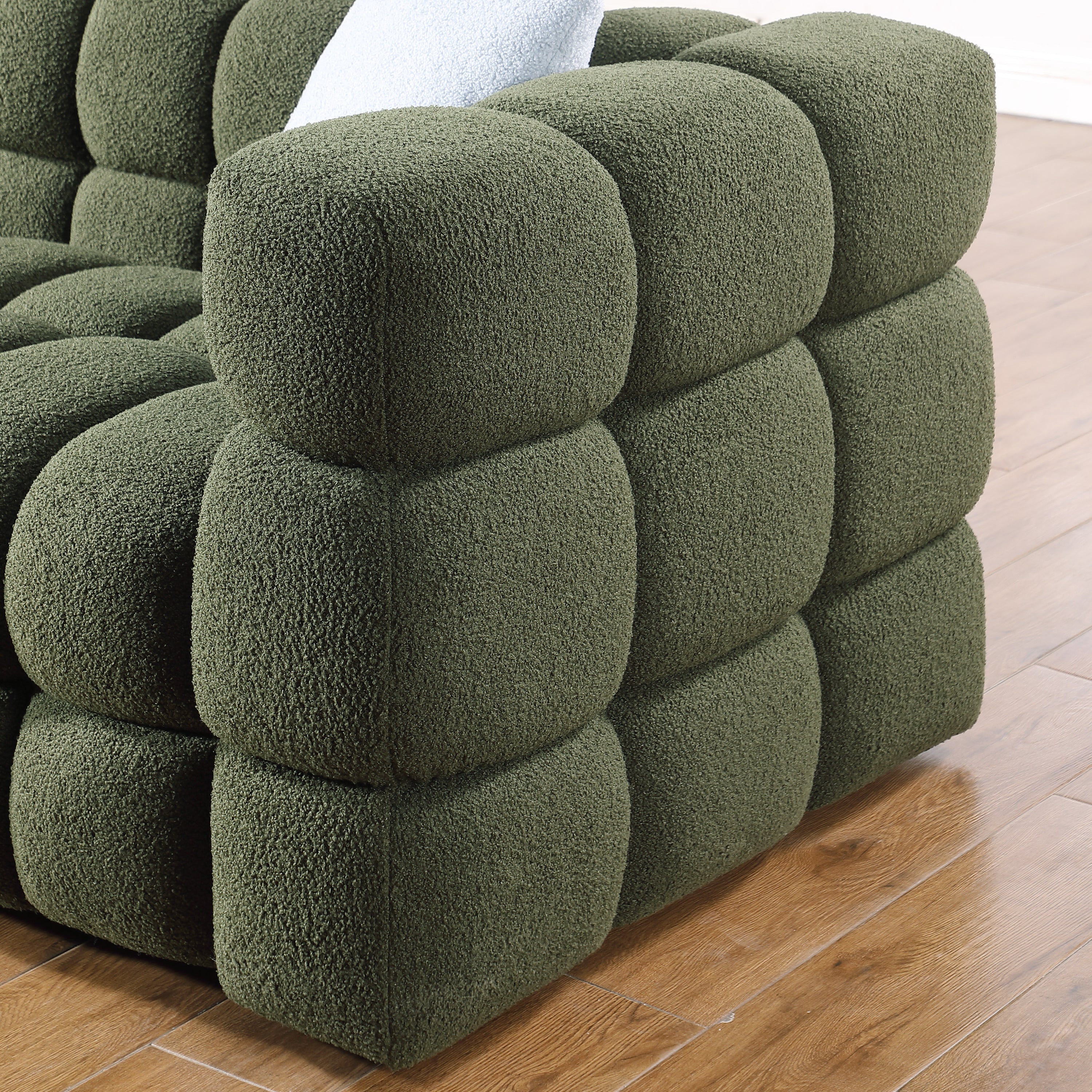 Side view of Olive Green Boucle Sofa - 3 Seater, Marshmallow Cozy showing rounded, tufted armrest and boucle texture.