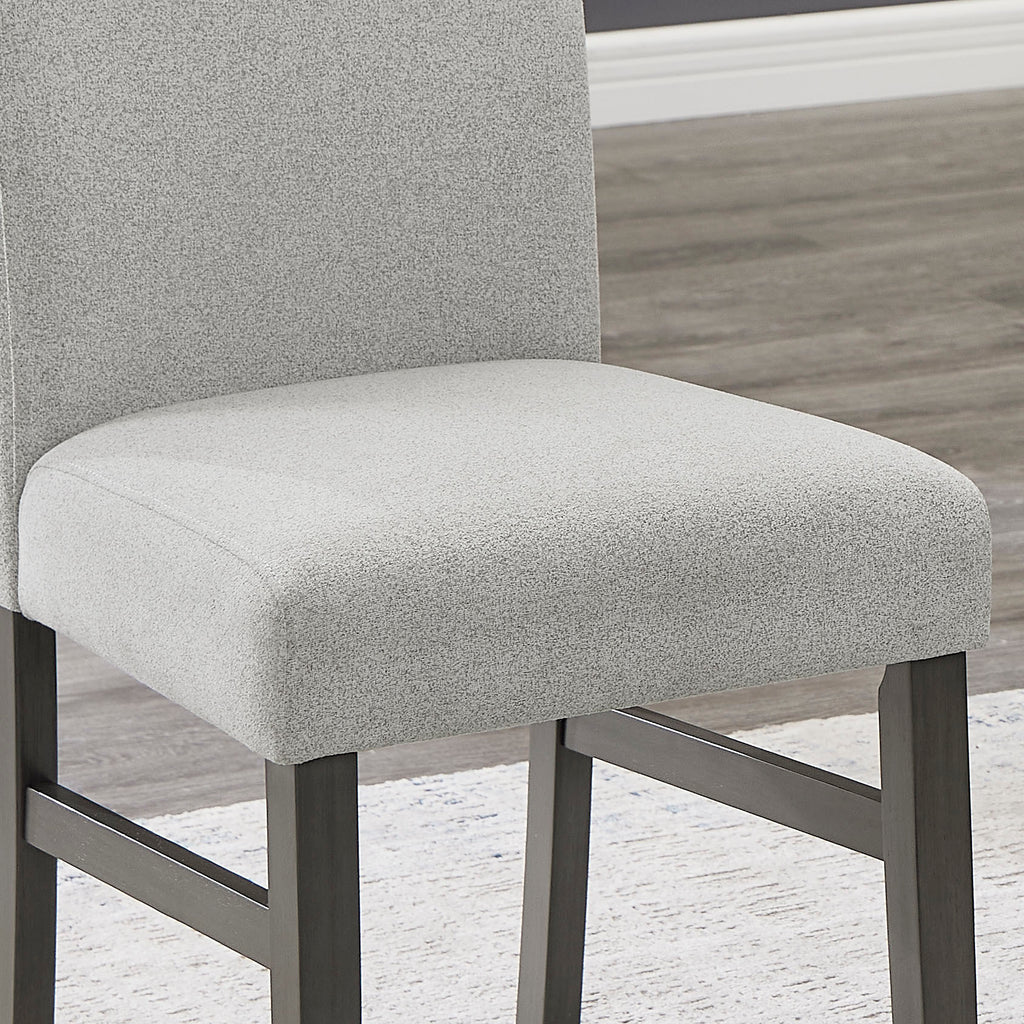 Close-up of Selena Dining Set chair showing soft light gray upholstery and durable dark wood frame for comfort and style.