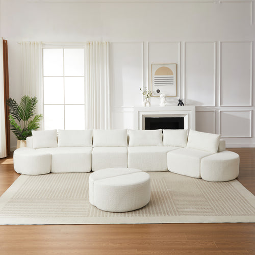 Beige chenille modular sectional sofa with decorative pillows and matching curved footstools in a bright living room.