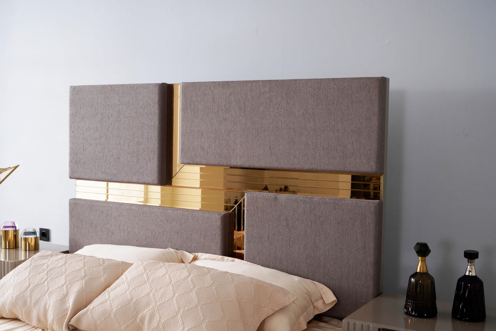Side angle of Lorenzo Queen Bed headboard showing gray fabric panels and gold accents, part of a modern bedroom collection.