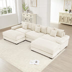 Oversized cream corduroy modular sectional sofa with deep seats, wide armrests, and a matching ottoman.