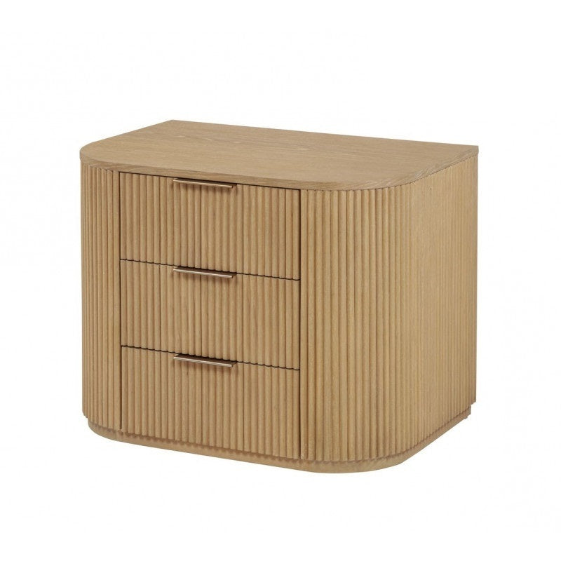 Modern light oak nightstand with a rounded silhouette, vertical fluted details, and three drawers with slim metal pulls.