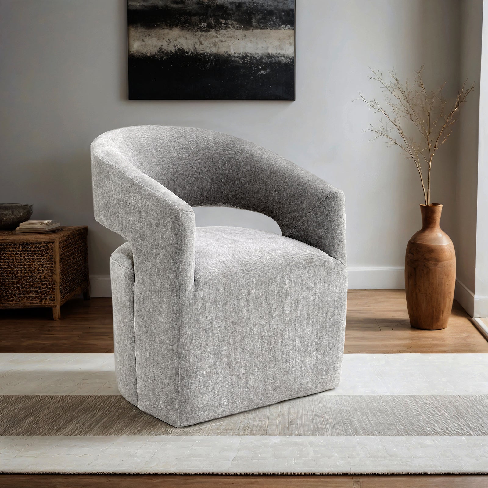 Contemporary Arm Chair with Casters in light gray fabric, barrel-back design, placed in a modern living room with wood flooring.