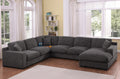 Gray chenille sectional sofa with right-facing chaise, charging ports, and cupholders in a bright living room with wood flooring.
