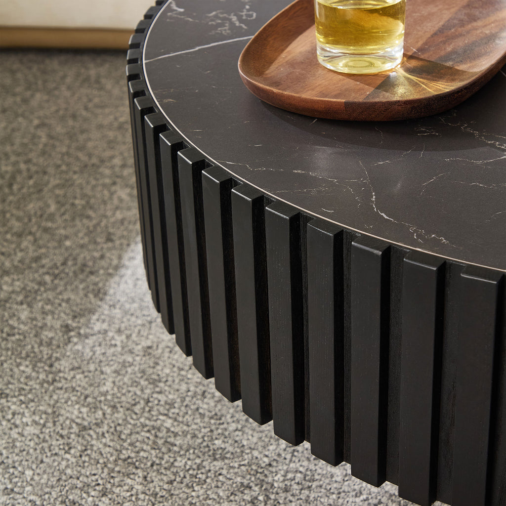Detail of the fluted edge design and black sintered stone top on the modern round coffee table, enhancing its stylish appeal.