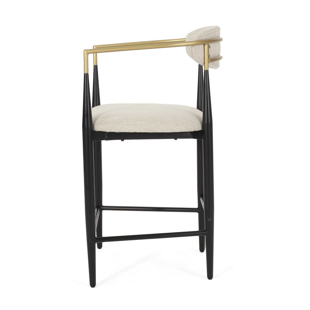 Side profile of modern counter stool highlighting curved gold backrest and plush beige cushion.
