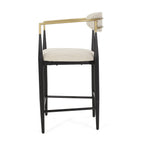 Side profile of modern counter stool highlighting curved gold backrest and plush beige cushion.