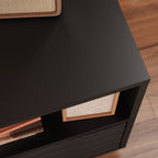 Top corner of black media console showing smooth matte finish and open shelf with framed photo and books.