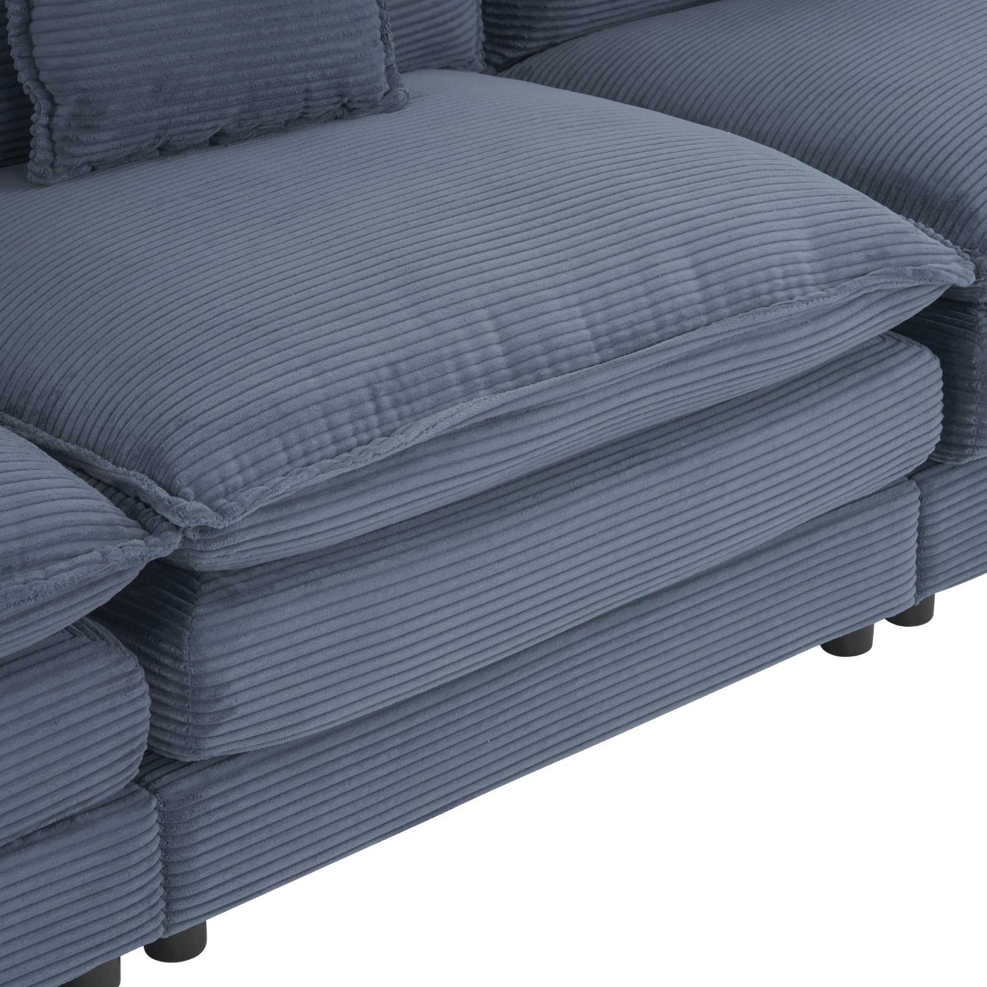 Close-up of the plush seat cushion on the blue corduroy modular sofa. Thick padding ensures maximum comfort for everyday lounging.