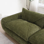 Top view of armrest and cushion on green 116'' compressed sofa, highlighting thick padding and no-assembly convenience.