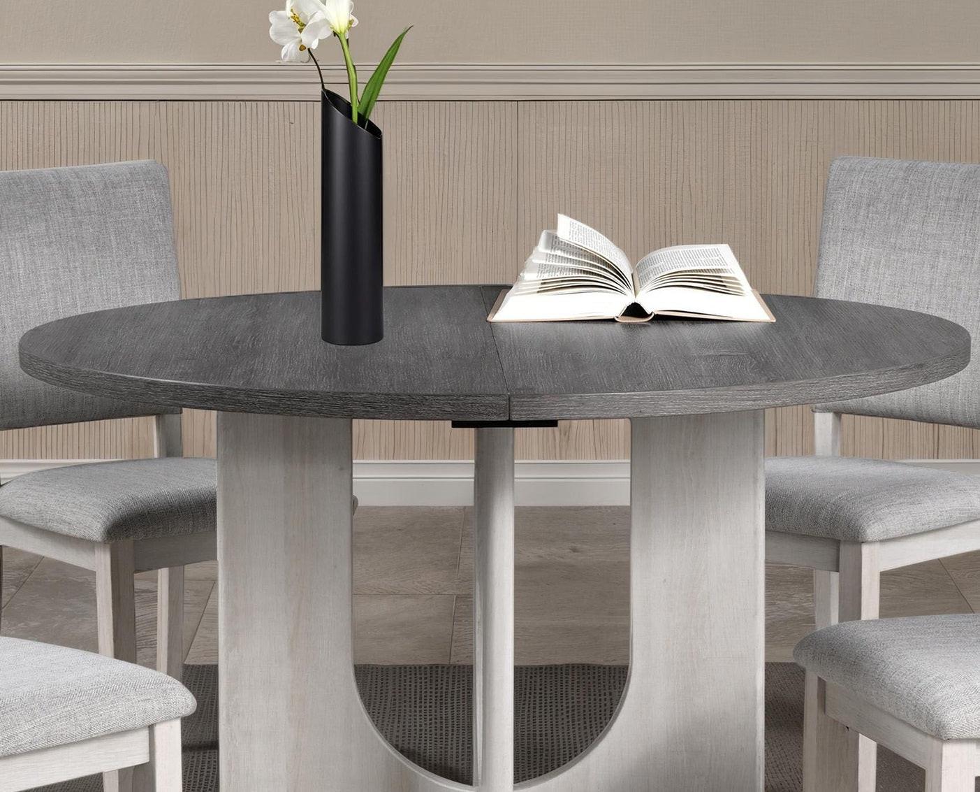 5pc dining set with gray upholstered chairs and round table.