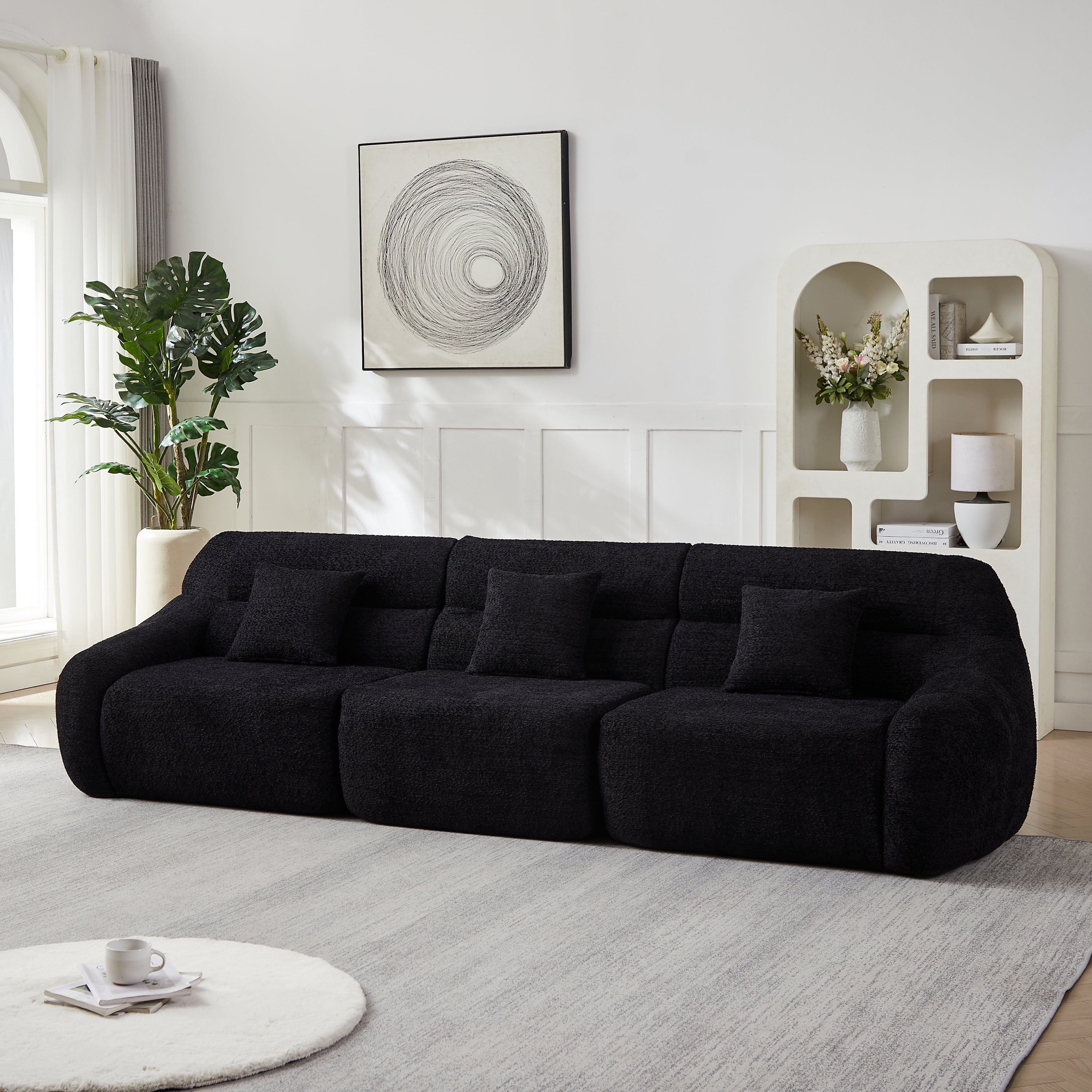 Full-length 4-seater Modern Black Modular Sofa in chenille, styled against a white wall with modern decor and soft area rug.