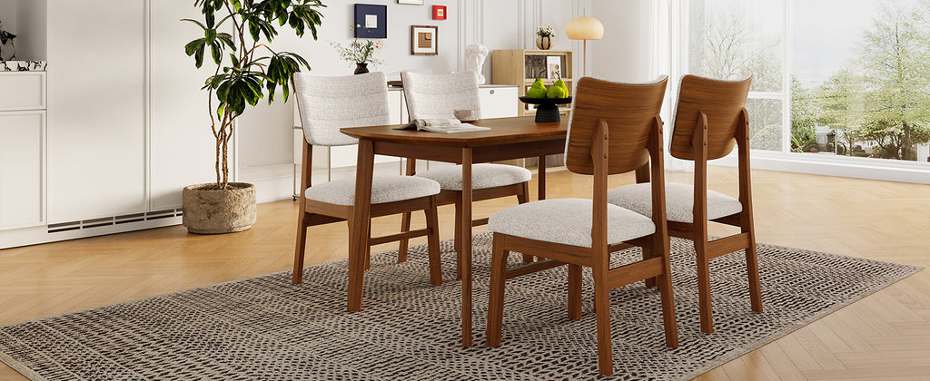 Farmhouse dining table set for 4 with wood and upholstered chairs, shown in a stylish room with natural lighting.
