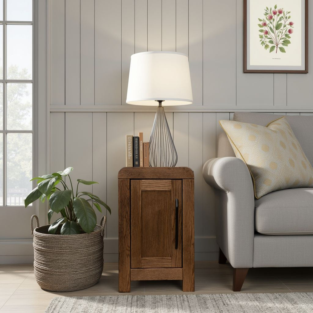 15 inch Oak Chairside Table - Haven placed next to a gray couch and plant basket. Features black hardware and hidden interior storage.