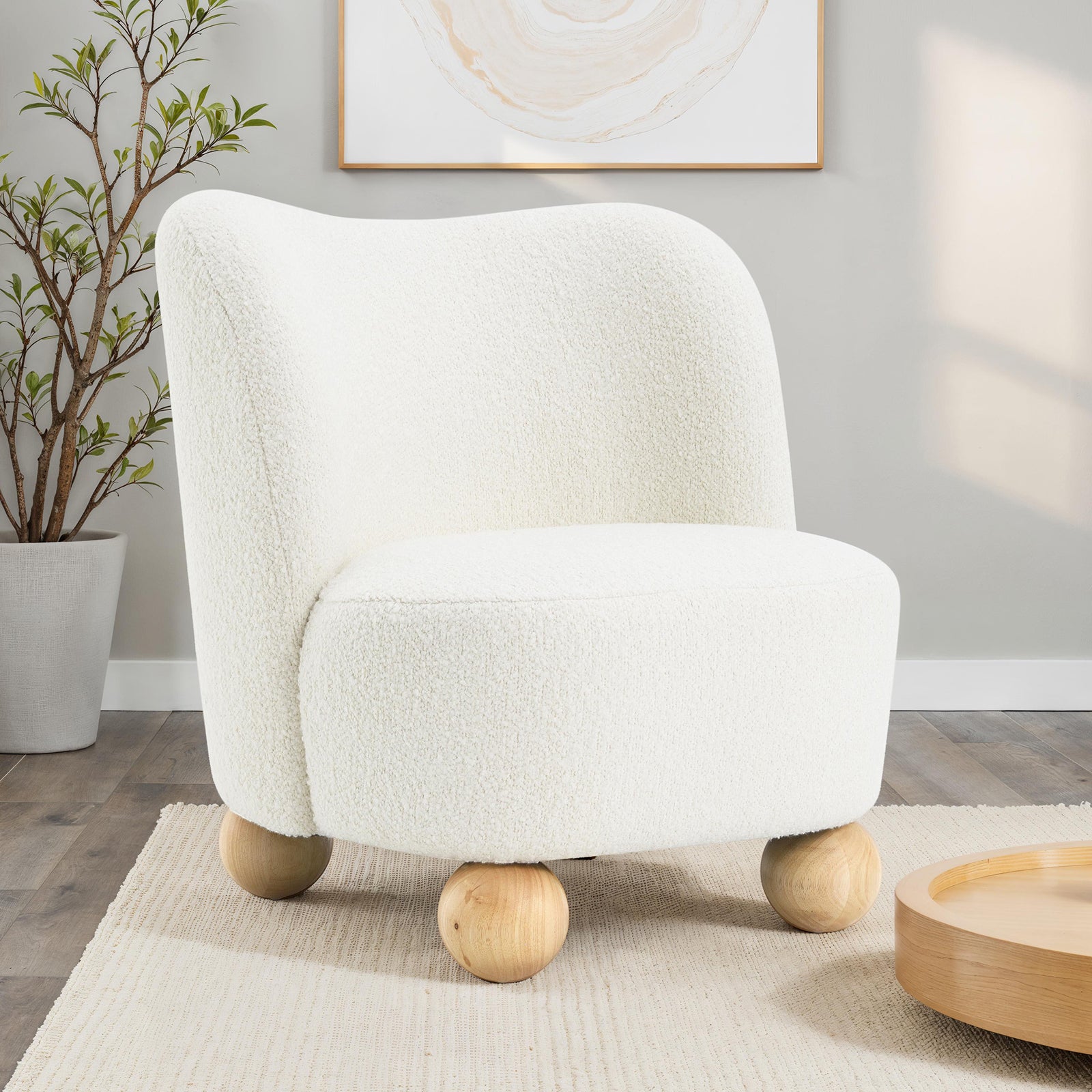 Modern Boucle Upholstered Accent Chair with Curved Back and rounded wooden legs, styled in a minimalist interior setting.